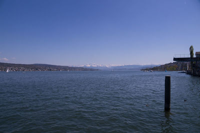 Scenic view of sea against clear blue sky