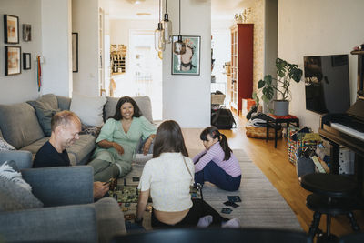 Family relaxing at home playing board games