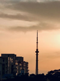 Silhouette buildings against sky during sunset