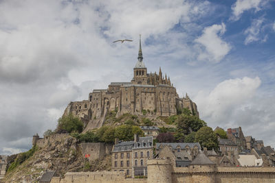 Low angle view of historical building against cloudy sky