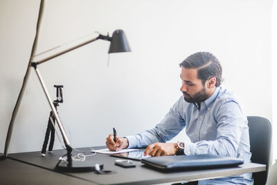 Creative businessman working at desk in office