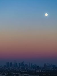 Scenic view of buildings against sky at dusk