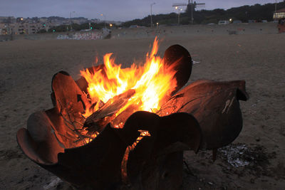 Bonfire on sand against sky