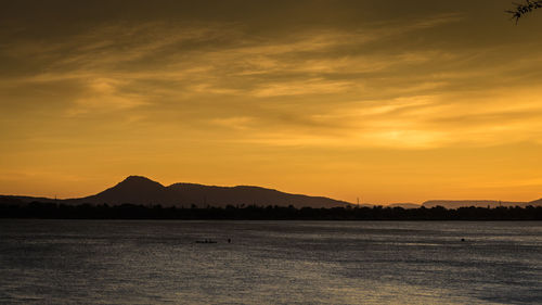 Scenic view of sea against romantic sky at sunset