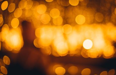 Defocused image of illuminated christmas lights at night