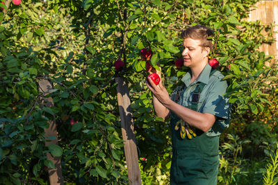 Portrait of young woman holding christmas tree
