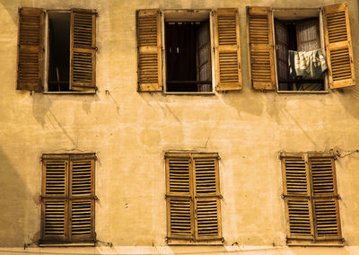 Golden hour, facade with windows, three opened and three closed, sunset, sunlight 