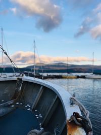 Boats moored in marina at sunset