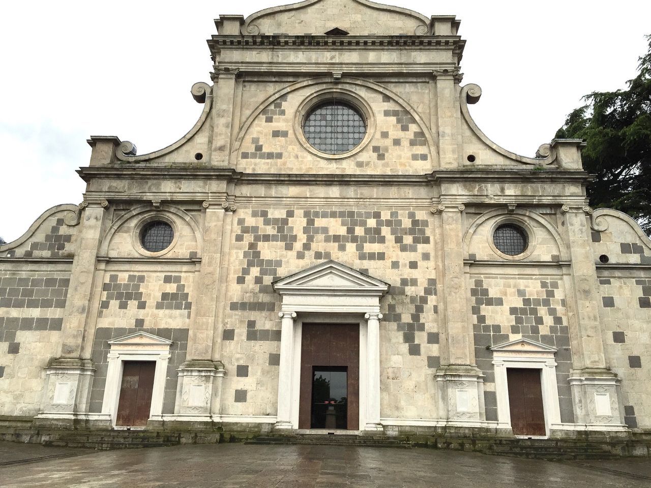 building exterior, architecture, built structure, facade, low angle view, window, religion, history, church, arch, entrance, sky, place of worship, outdoors, day, old, door, spirituality, clear sky