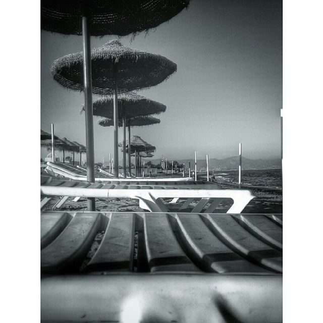 transfer print, auto post production filter, water, sky, reflection, transportation, sea, built structure, railing, architecture, empty, no people, tree, clear sky, outdoors, day, absence, sunlight, street light, nature