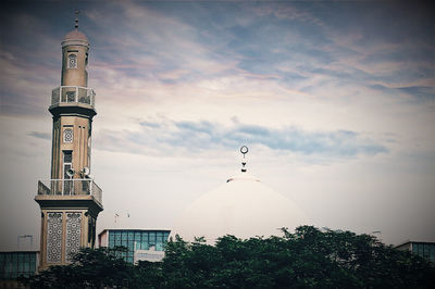 Low angle view of tower against cloudy sky