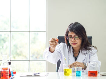 Doctor analyzing chemicals in laboratory