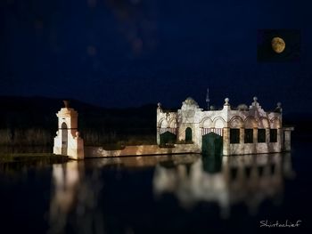 Reflection of building in water at night