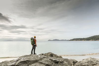 Man exploring the coast and jumping ove the rocks