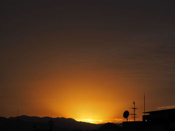 Silhouette mountains against sky during sunset