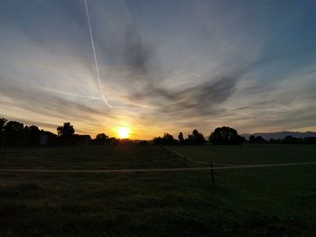 Scenic view of field against sky during sunset