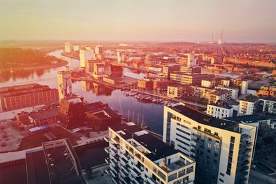 High angle view of buildings in city during sunset