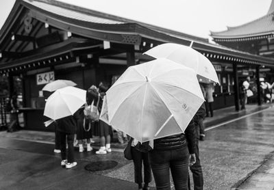 Woman holding umbrella in city