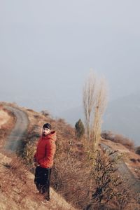 Man standing on field against clear sky