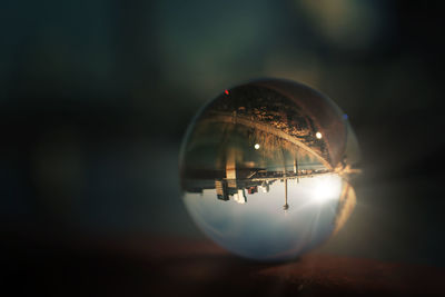 Close-up of crystal ball on glass