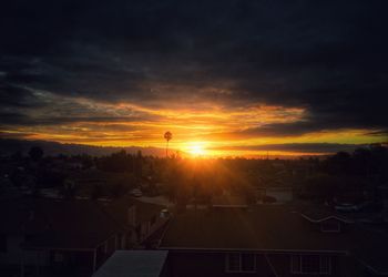 High angle view of cityscape against cloudy sky during sunset