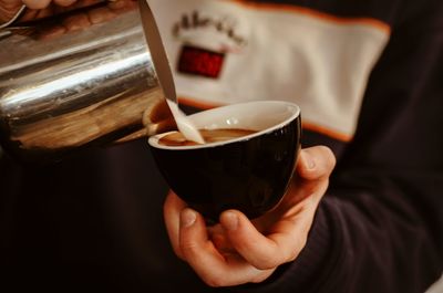 Close-up of hand holding coffee cup