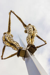 Low angle view of insect on metal against sky