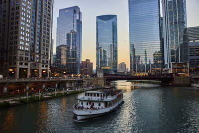 Boats in river in city