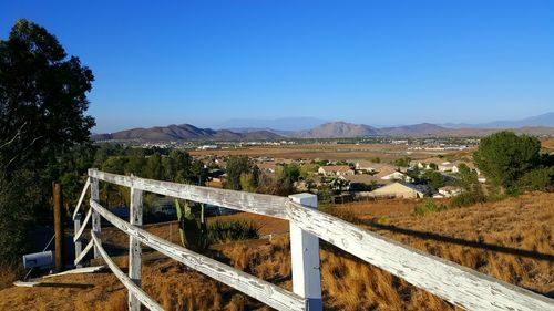 Bridge over landscape against clear blue sky