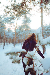Young woman enjoying winter weather in the snow forest. cold weather. winter holidays, rest, travel 