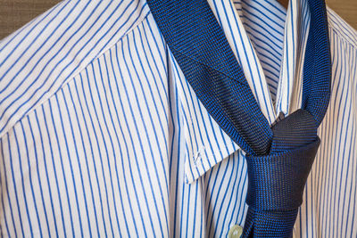 Close-up of shirt and necktie hanging on coathanger