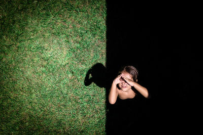 Directly above shot of girl standing on field