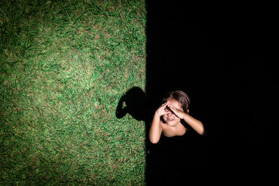 Young woman standing on grass