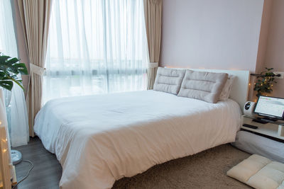 White curtain on bed at home