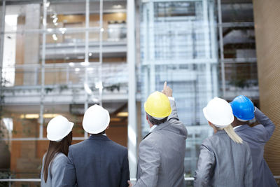 Rear view of man standing in factory