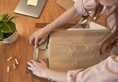 Midsection of woman working on table