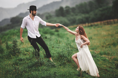 Full length of young woman on field