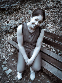 Portrait of a smiling young woman sitting outdoors