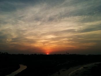 Scenic view of silhouette trees against sky at sunset