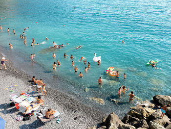 High angle view of people enjoying on beach