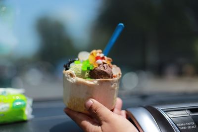 Close-up of hand holding ice cream