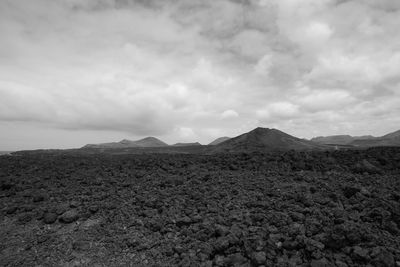 Scenic view of vulcanic arid landscape against sky