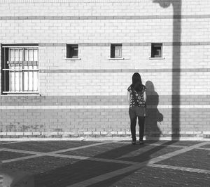 Full length of woman standing in front of building