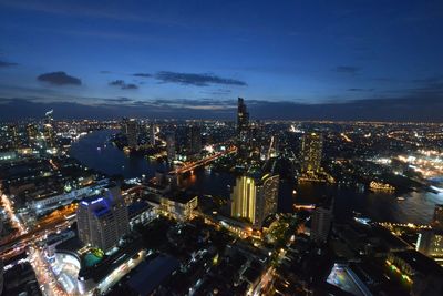 Illuminated cityscape against sky at night