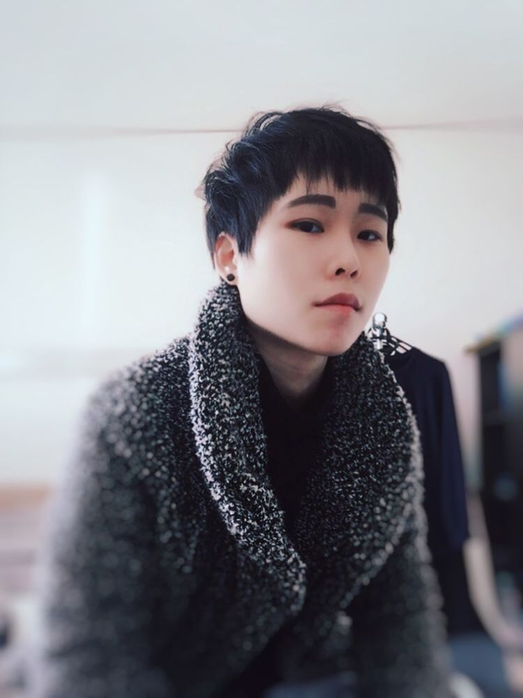 one person, lifestyles, real people, young adult, looking, leisure activity, portrait, front view, indoors, focus on foreground, looking away, clothing, waist up, casual clothing, warm clothing, winter, sweater, young men, contemplation, hairstyle, bangs, innocence, scarf