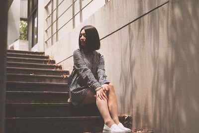 Young woman sitting on steps