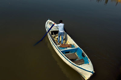 High angle view of man standing on boat