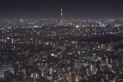 High angle view of city lit up at night