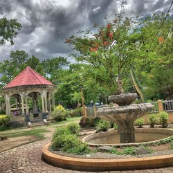 Gazebo by trees against sky