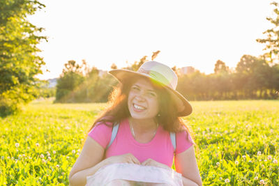 Portrait of smiling young woman on field